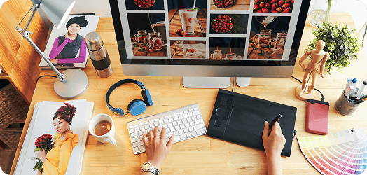 Design studio team reviewing creative work on large displays